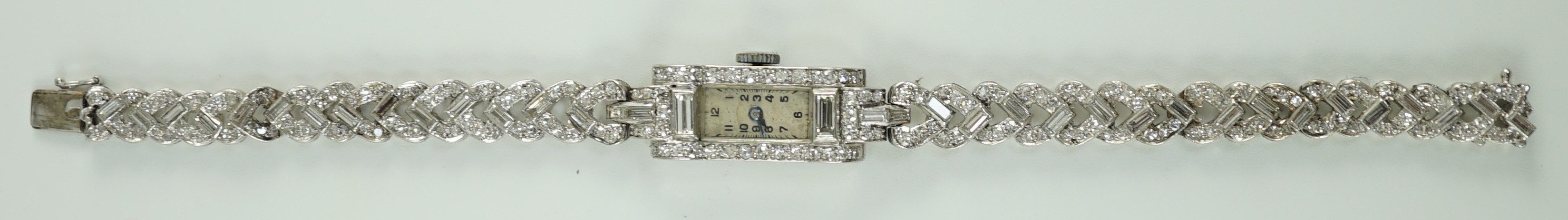 A lady's 1930's/1940's platinum, baguette and round cut diamond set rectangular dial manual wind cocktail watch, on a white gold and baguette and round cut diamond set bracelet, with Asprey box